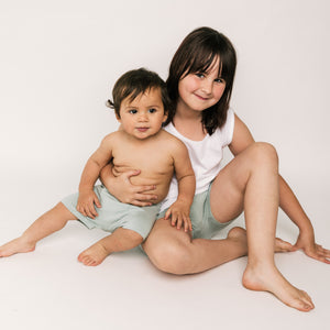 Child wearing Shorties – reusable shorts-style training pants for day or night